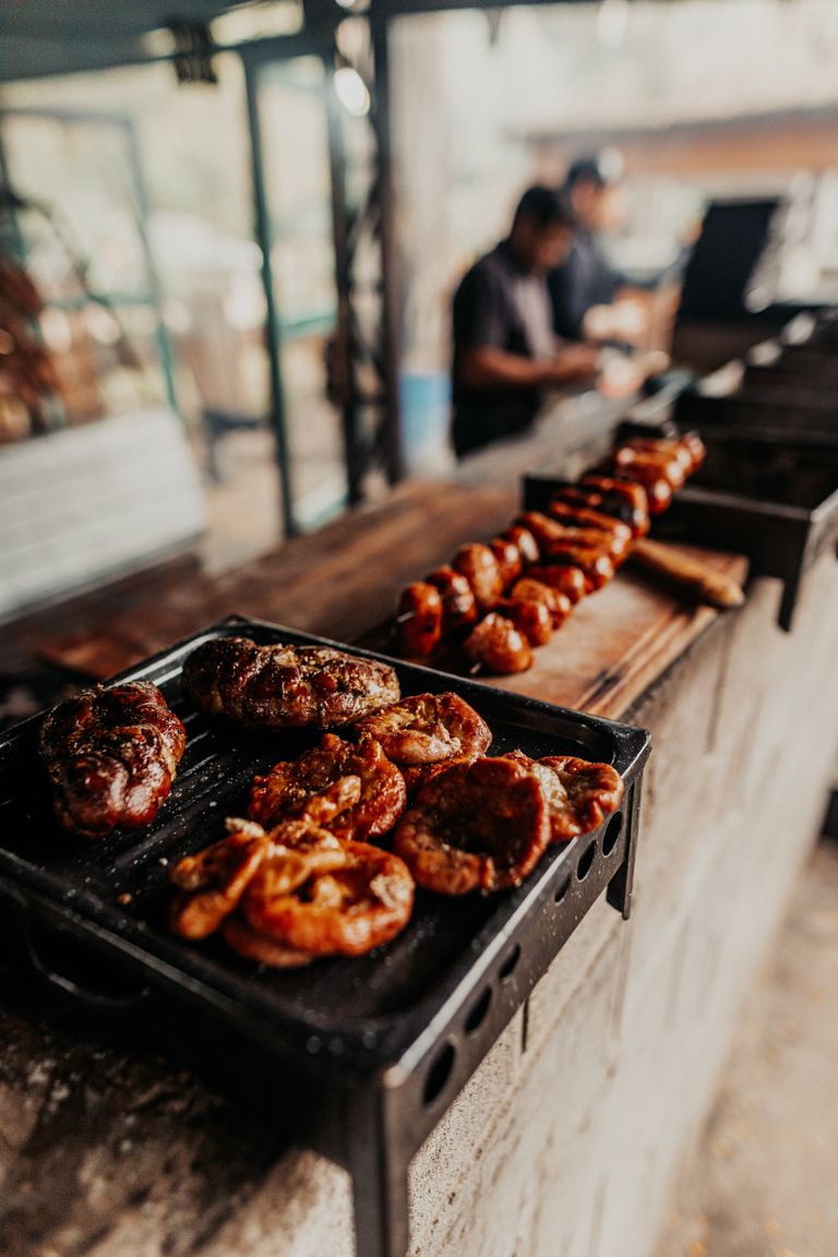 Delicious Argentine asado being grilled outdoors at a local eatery in Buenos Aires.