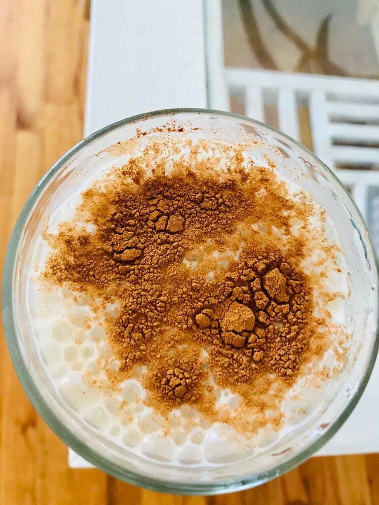 Delicious close-up of a cinnamon-topped milkshake, perfect for a sweet treat.